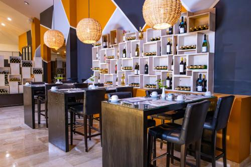 a restaurant with tables and chairs and chandeliers at Smart Cancun the Urban Oasis in Cancún