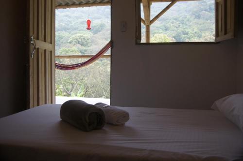 Una cama o camas en una habitación de Hostal Vista Verde Minca
