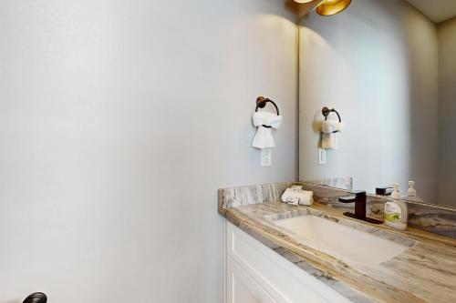 a bathroom with a sink and a mirror at Surf M' Oceans in Myrtle Beach