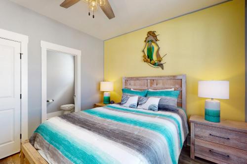 a bedroom with a bed and two lamps and a mirror at Surf M' Oceans in Myrtle Beach