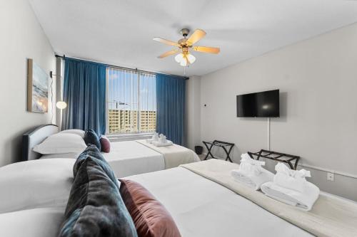 a hotel room with two beds and a ceiling fan at Chic DC Getaway Near Metro in Arlington
