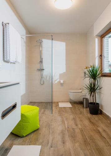a bathroom with a glass shower and a tub at Bungalow Appartements - "Studio Living" in Haselünne