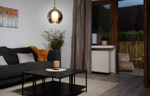a living room with a couch and a table at Bungalow Appartements - "Studio Living" in Haselünne
