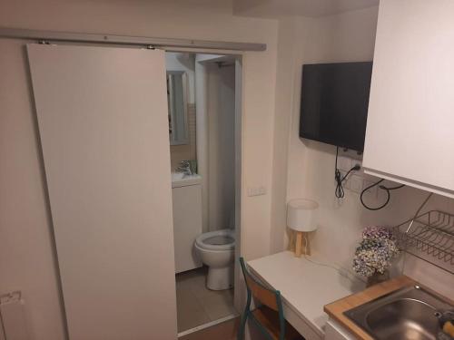 a bathroom with a toilet and a sink and a table at Studette Rémilly à Versailles in Versailles