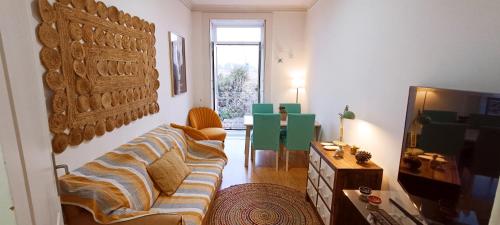 a living room with a couch and a television at Chill and Fun - Matosinhos - ONLY ROOM in Matosinhos