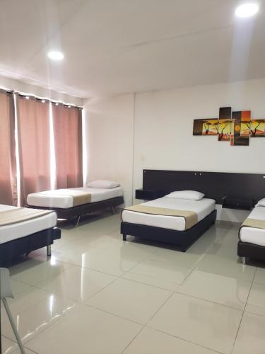 Ein Bett oder Betten in einem Zimmer der Unterkunft Hotel Suite Center Pereira
