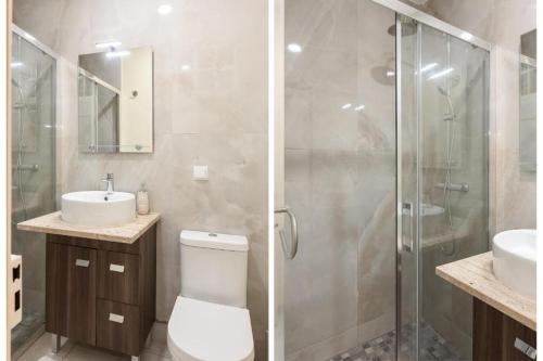 a bathroom with a shower and a toilet and a sink at Grand studio 29 in Faro