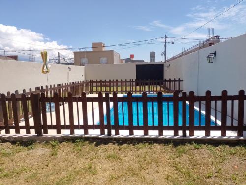 a wooden fence next to a swimming pool at Paz y Eva in Salta