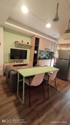 a living room with a table and a couch at Riz Property in Jakarta