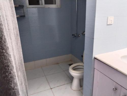 a bathroom with a toilet and a shower at Bourbon Bliss guest house in Rawalpindi