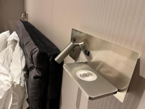a stainless steel sink in a room next to a bed at Anemoni Piraeus Hotel in Piraeus