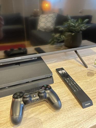 two video game controllers on a table next to a tv at Oase der Ruhe - mit viel Platz 