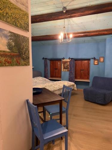 a living room with a table and a couch at [Stanza Lavanda] in Varzi