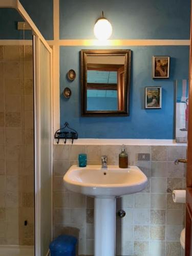 a bathroom with a sink and a mirror at [Stanza Lavanda] in Varzi