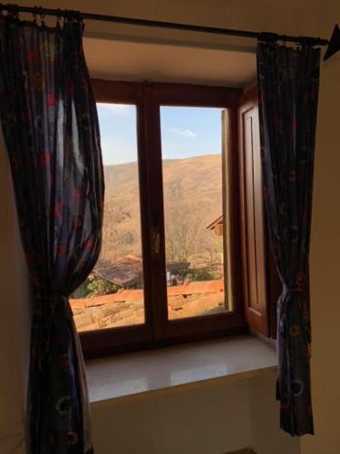 a window with a view of a mountain view at [Stanza Lavanda] in Varzi
