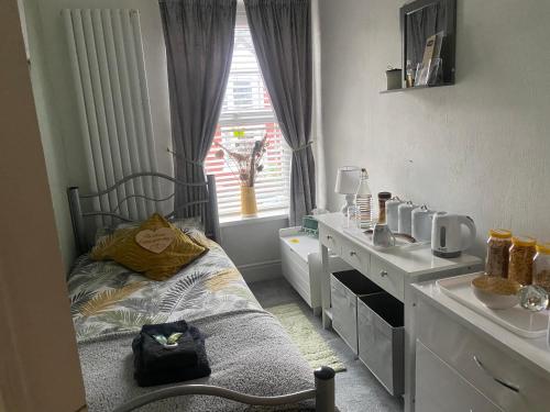 a childs bedroom with a bed and a sink at Butterfly House in Blackwood