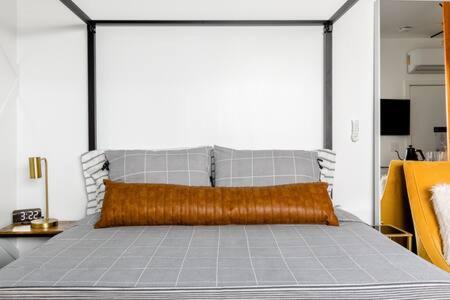 a bedroom with a large bed with a metal frame at Vibe on the Patio at a Modern Luxury Studio near LAX Beach in Los Angeles