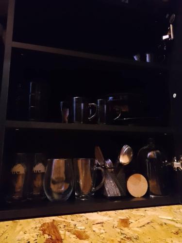 a shelf with various pots and pans and utensils at Zaciszny Zakątek Zawoja in Zawoja