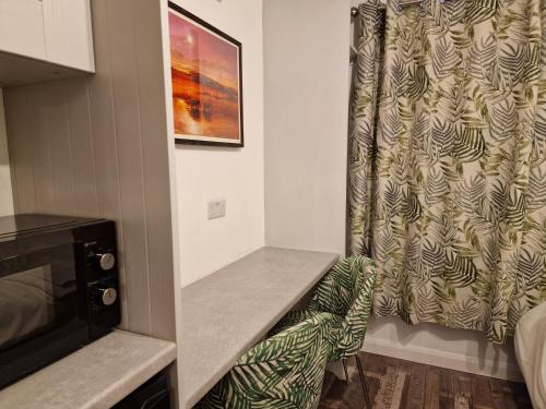a small room with a table and a microwave at The Little Annex in Horsham