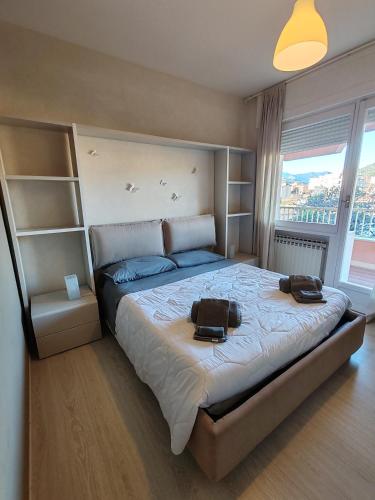 a bedroom with a large bed with two bags on it at Relax al Mare in Vallecrosia