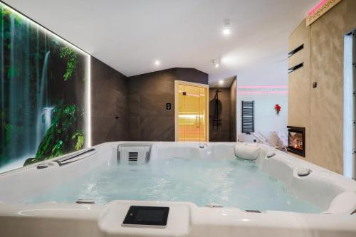 a bath tub with a tablet in it in a bathroom at Domek Zakopane Deluxe & Spa na wyłączność in Zakopane