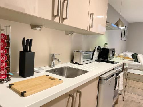 a kitchen with a sink and a microwave at HNFC Stays - Central Business Studio w/ gym in Newcastle upon Tyne