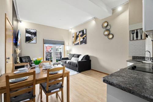 a kitchen and living room with a table and a couch at European style Queen Suite in Palm Coast - Best view with Balcony near Beaches! in Palm Coast