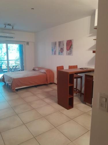 a bedroom with a bed and a desk and a table at Excelente departamento en Villa Luro in Buenos Aires