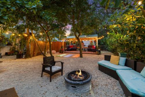 a fire pit in a yard with a couch and chairs at The New Yorker Miami Hotel in Miami