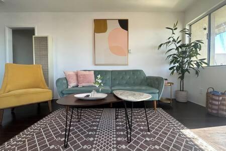 a living room with a green couch and a coffee table at Ocean View 1 Bedroom Manhattan Beach in Manhattan Beach