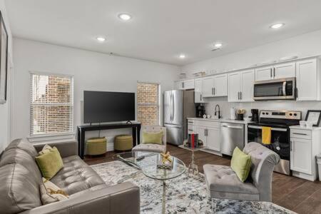 a large living room with a couch and a table at The Warhol - Pet-Friendly Apartment in Bentonville