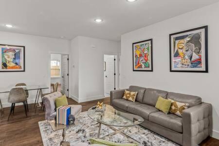 a living room with a couch and a table at The Warhol - Pet-Friendly Apartment in Bentonville