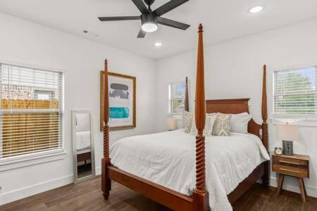 a bedroom with a bed and a ceiling fan at The Warhol - Pet-Friendly Apartment in Bentonville