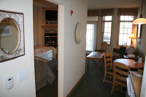 a living room and a dining room with a mirror at Birchwood Lodge in Sister Bay