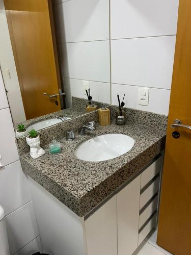 a bathroom counter with a sink and a mirror at Apartamento premium - Df plaza in Brasilia