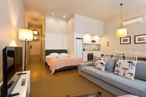 a living room with a couch and a bed at RVA - Porto Central Flats in Porto