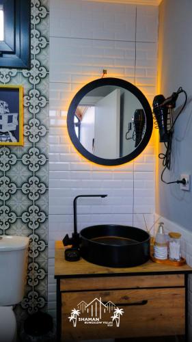 a bathroom with a black sink and a mirror at Şile SHAMAN BUNGALOW VİLLAS 102 in Şile