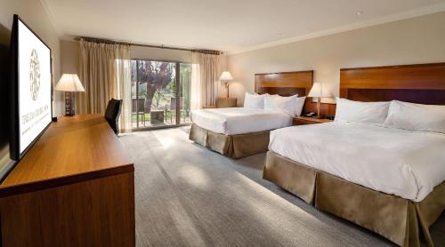 a hotel room with two beds and a large window at Temecula Creek Inn in Temecula