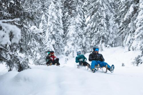 a group of people sitting in the snow at Landhaus Wieser in Ramsau am Dachstein