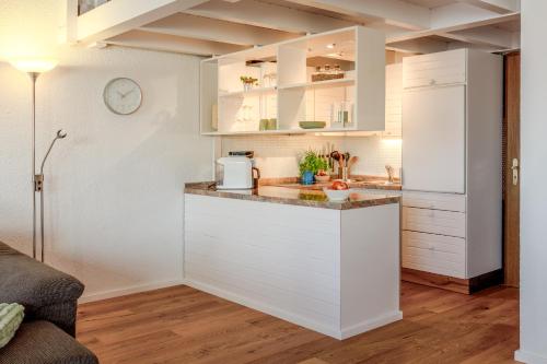 a kitchen with white cabinets and a counter top at Fewo Sommernachtstraum in Gaienhofen