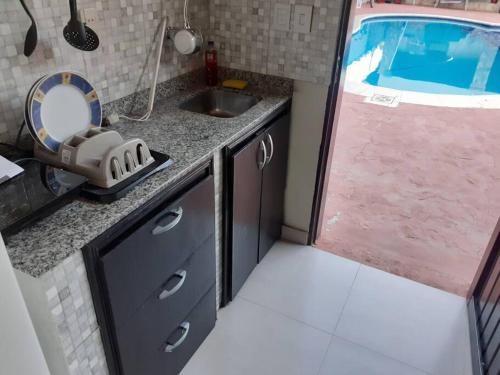 a small kitchen with a sink and a tub at Mar Azul in San Lorenzo