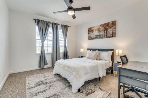 a white bedroom with a bed and a desk at Luxury 1Bedroom Apt with Pool in Austin