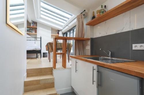 a kitchen with a sink and a counter top at Amazing Mazarine Studio in Paris