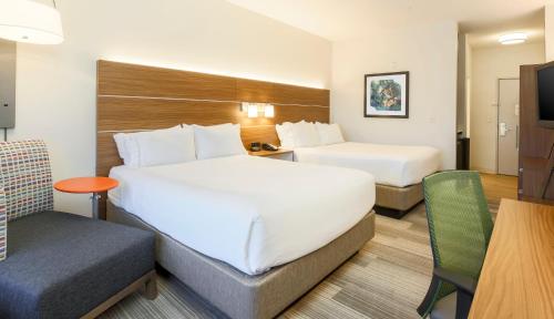 a hotel room with two beds and a desk at Holiday Inn Express Las Vegas Stadium Area by IHG in Las Vegas