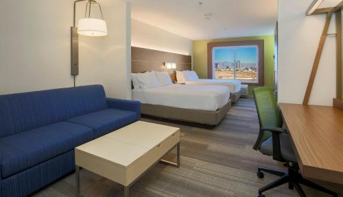 a hotel room with two beds and a couch at Holiday Inn Express Las Vegas Stadium Area by IHG in Las Vegas