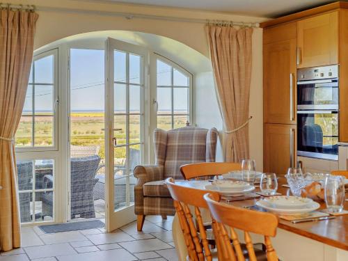 a kitchen and dining room with a table and chairs at 3 Bed in Nr Bamburgh CN069 in Kyloe