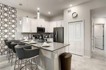 a kitchen with a counter and some bar stools at Dazzling Thematic 2BR with Game Room in Davenport