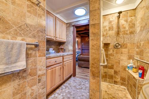 a bathroom with a walk in shower and a sink at Cozy Harbor Springs Vacation Rental, 13 Mi to Town in Harbor Springs