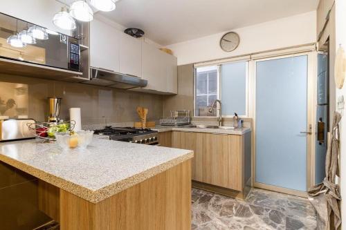 a kitchen with a sink and a counter top at Ro Prime. Stylish & Comfortable With Jacuzzi & A/C in Guadalajara