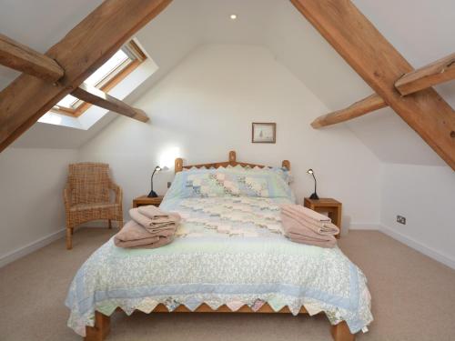 a bedroom with a bed in the attic at 2 Bed in Cheddar TFORG in Butcombe